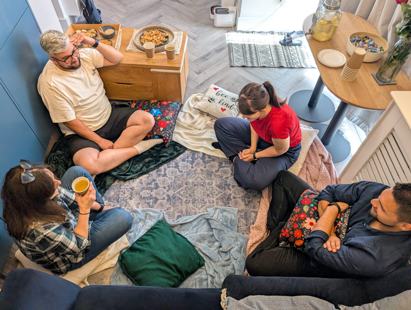 A small, intimate storytelling circle gathered in a warm library room